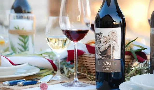 Le Vigne Winery in Paso Robles Pictured Malbec Wine Botlle wth Wine Glasses at a table