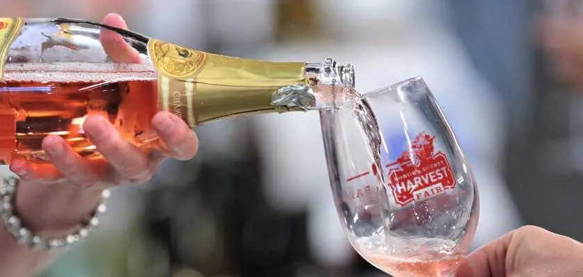 Wine is being poured into a glass at the fair.