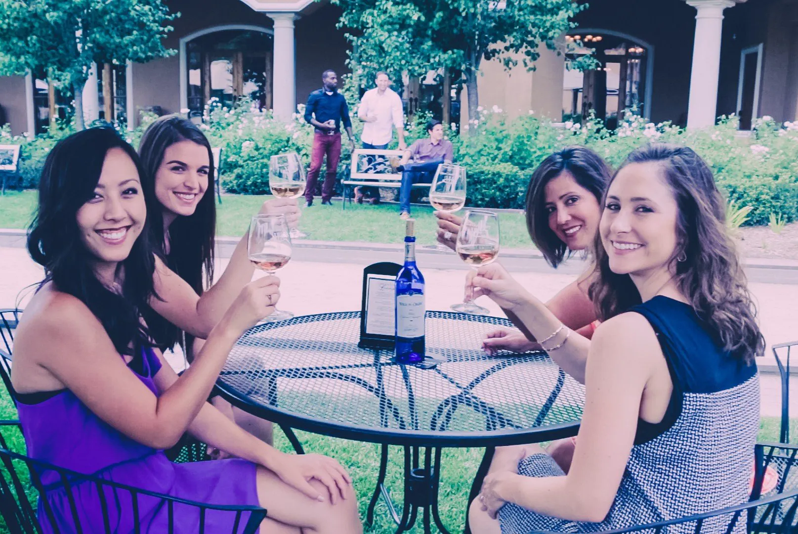 Four ladies at a table toasting
