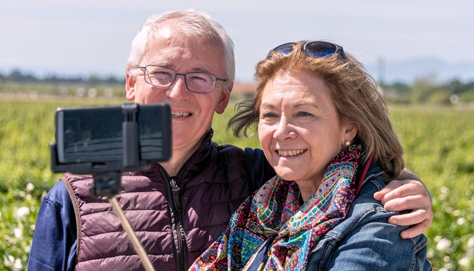A couple taking a selfie at a vineyard